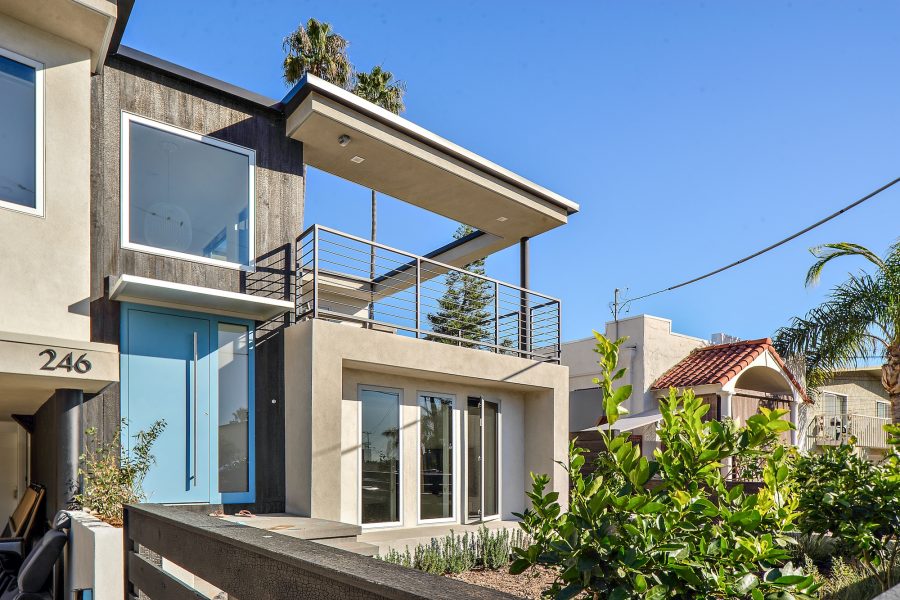 modern front of home with stucco and shou sugi ban exterior